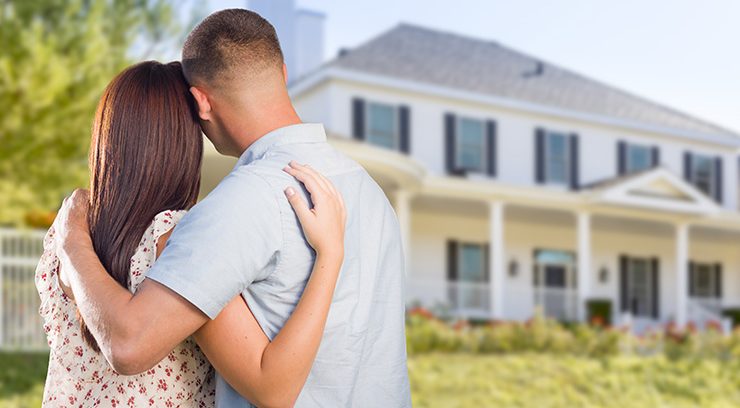 image of couple looking at nice new house