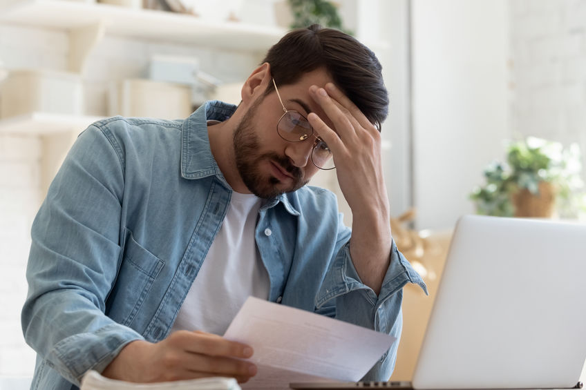 image of a man stressed about bills